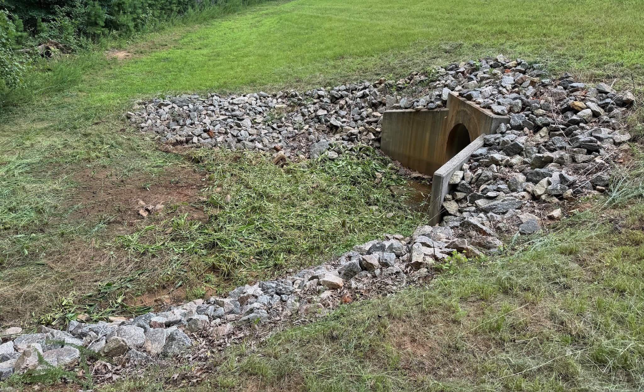 Checking outlet, riser, trash rack, and embankment with notes for safety and service access